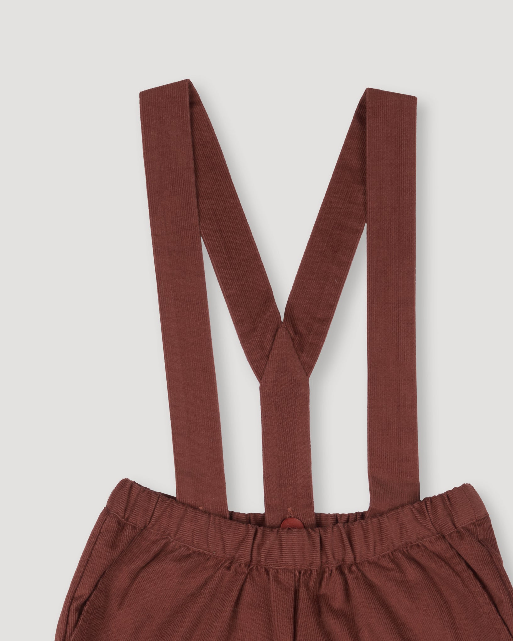 Early Sunday, Joseph Short Dungaree in Caramel, made from Cotton Corduroy fabric, featuring short dungaree with adjustable straps, shown in a closeup flat-lay view