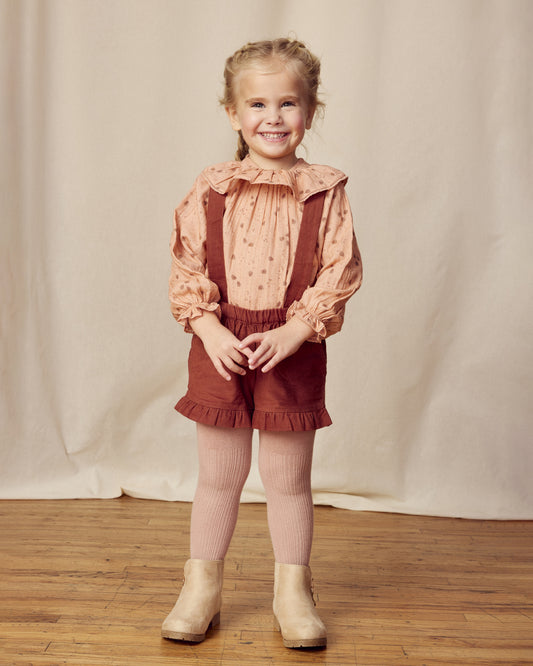 Early Sunday, Joseph Short Dungaree in Caramel, made from Cotton Corduroy fabric, featuring short dungaree with adjustable straps, shown in a front view of model wearing it