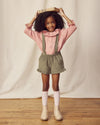 Early Sunday, Joseph Short Dungaree in Moss, made from Cotton Corduroy fabric, featuring short dungaree with adjustable straps, shown in a front view of model wearing it