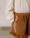 Early Sunday, Joseph Short Dungaree in Almond, made from Dyed Cotton Velvet fabric, featuring Softly structured short dungaree with classic detailing for a vintage-inspired look, shown in a close-up shot of the print