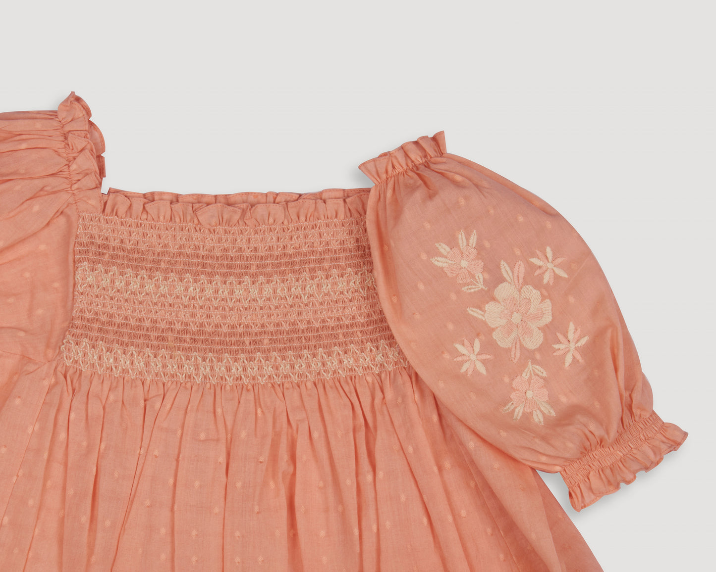 Early Sunday, Judith Blouse in Strawberry color, made from Cotton Dobby Swiss Dots fabric, featuring relaxed fit with delicate finishes, combining style and functionality, shown in a closeup flat-lay view