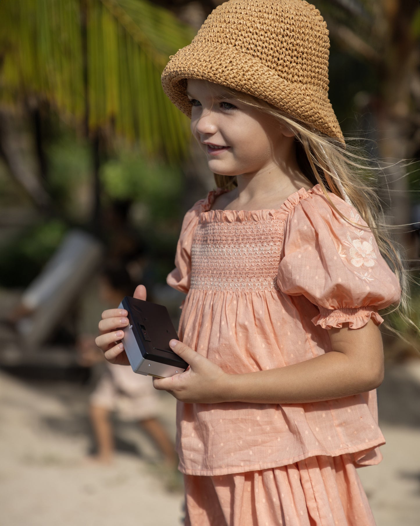 Early Sunday, Judith Blouse in Strawberry color, made from Cotton Dobby Swiss Dots fabric, featuring relaxed fit with delicate finishes, combining style and functionality, shown in a side view of model wearing it
