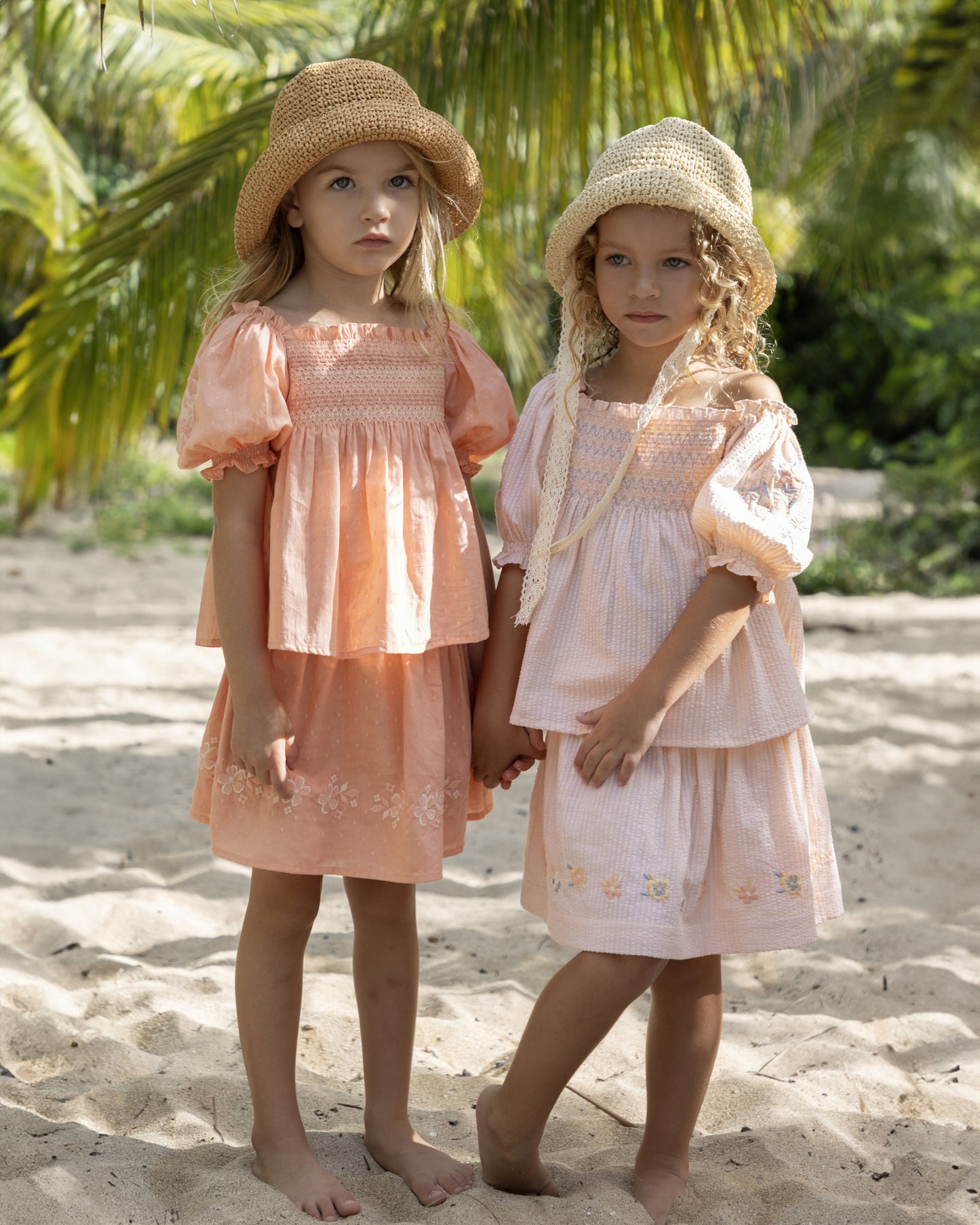 Early Sunday, Judith Blouse in Strawberry color, made from Cotton Dobby Swiss Dots fabric, featuring relaxed fit with delicate finishes, combining style and functionality, shown in a front view of models wearing outdoors