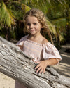 Early Sunday, Judith Blouse in Warm Sand color, made from Cotton Seersucker fabric, featuring relaxed fit with delicate finishes, combining style and functionality, shown in a close-up side view of a model wearing it