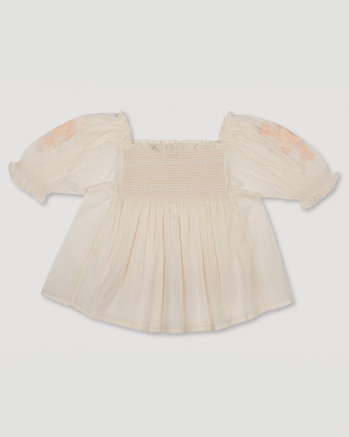 Early Sunday, Judith Blouse in Cream color, made from Cotton Voile fabric, featuring relaxed fit with delicate finishes, combining style and functionality, shown in a back flat-lay view