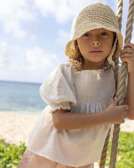 Early Sunday, Judith Blouse in Cream color, made from Cotton Voile fabric, featuring relaxed fit with delicate finishes, combining style and functionality, shown in a close up view of model wearing it