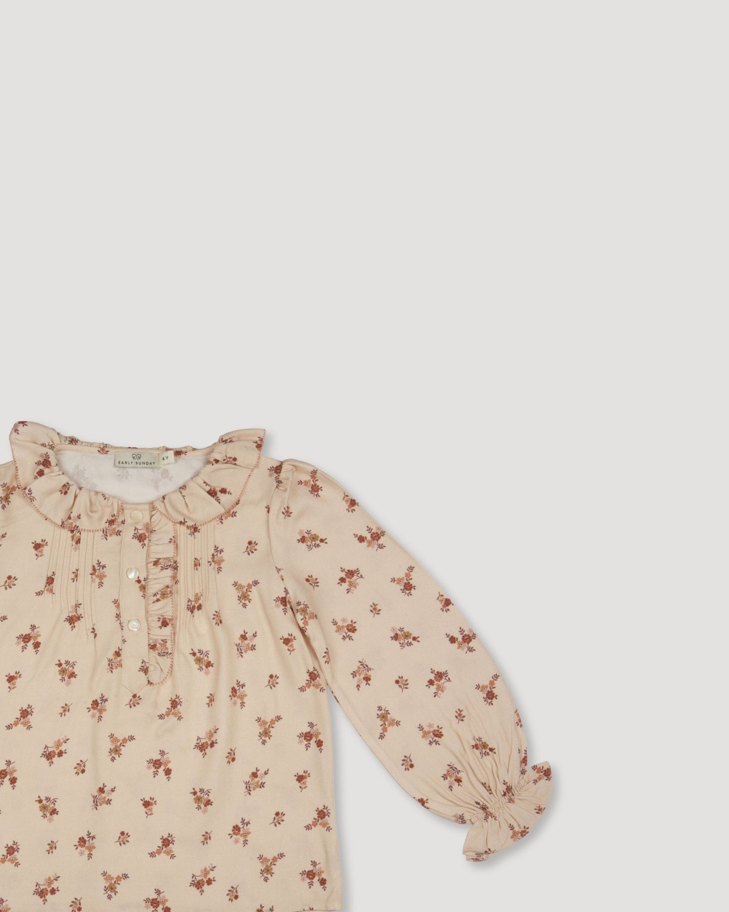 Early Sunday, Julianne Blouse in Ditsy Bouquet Cream print, made from Printed Viscose Rayon Twill fabric, featuring Comfort-first design with a playful silhouette, shown in a closeup flat-lay view