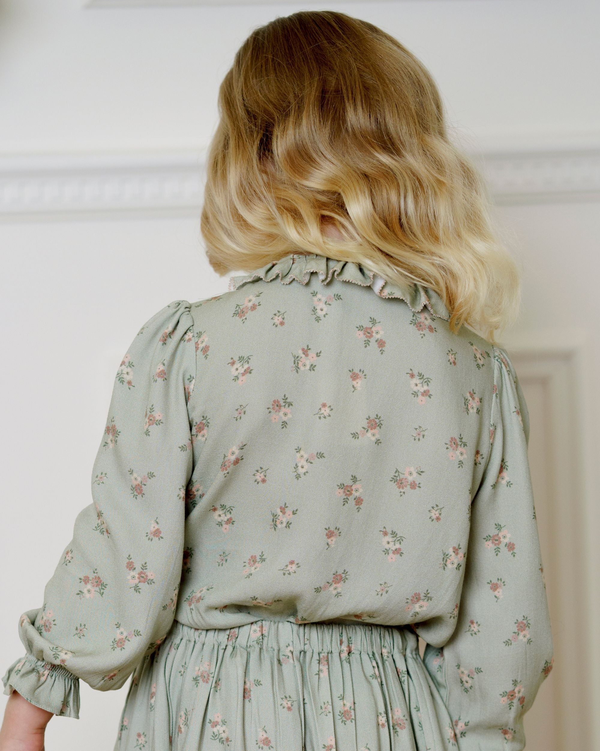 Early Sunday, Julianne Blouse in Ditsy Bouquet Jade print, made from Printed Viscose Rayon Twill fabric, featuring Comfort-first design with a playful silhouette, shown in a back view of model wearing it