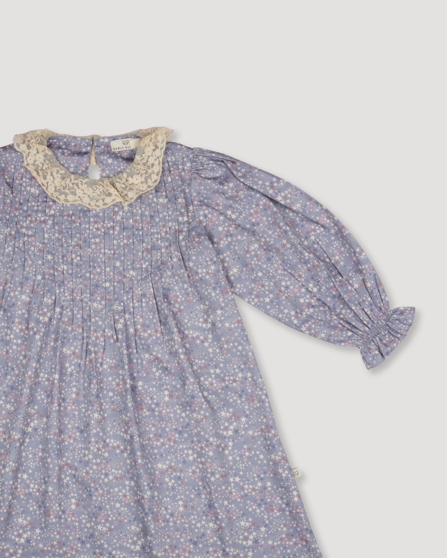 Early Sunday, Julie Dress in Celestial print, made from Printed Cotton Satin fabric, featuring Delicate lace collar paired with a softly structured silhouette for a refined, timeless finish, shown in a closeup flat-lay view
