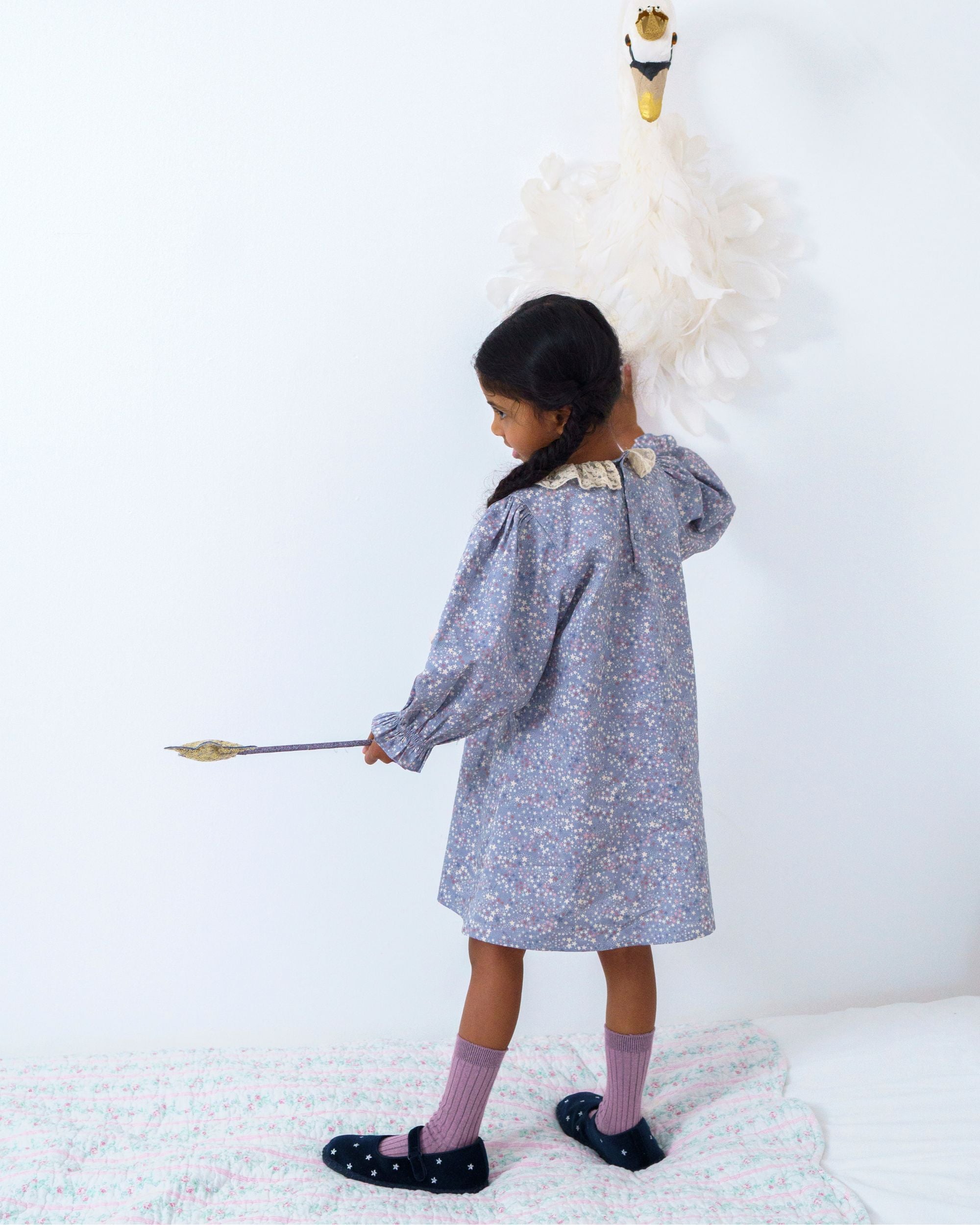 Early Sunday, Julie Dress in Celestial print, made from Printed Cotton Satin fabric, featuring Delicate lace collar paired with a softly structured silhouette for a refined, timeless finish, shown in a back view of model wearing it