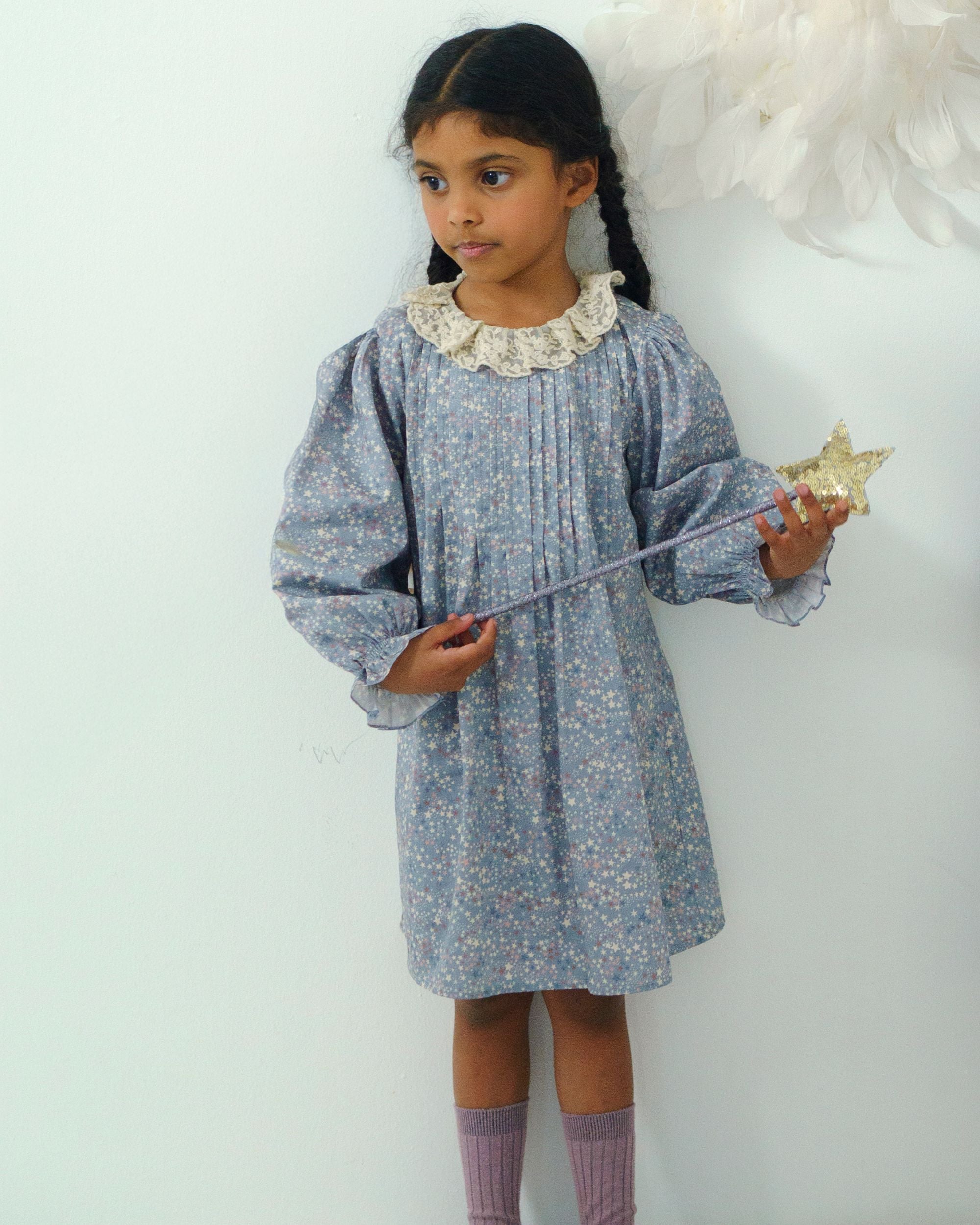 Early Sunday, Julie Dress in Celestial print, made from Printed Cotton Satin fabric, featuring Delicate lace collar paired with a softly structured silhouette for a refined, timeless finish, shown in a front view of a model wearing it in a studio setting