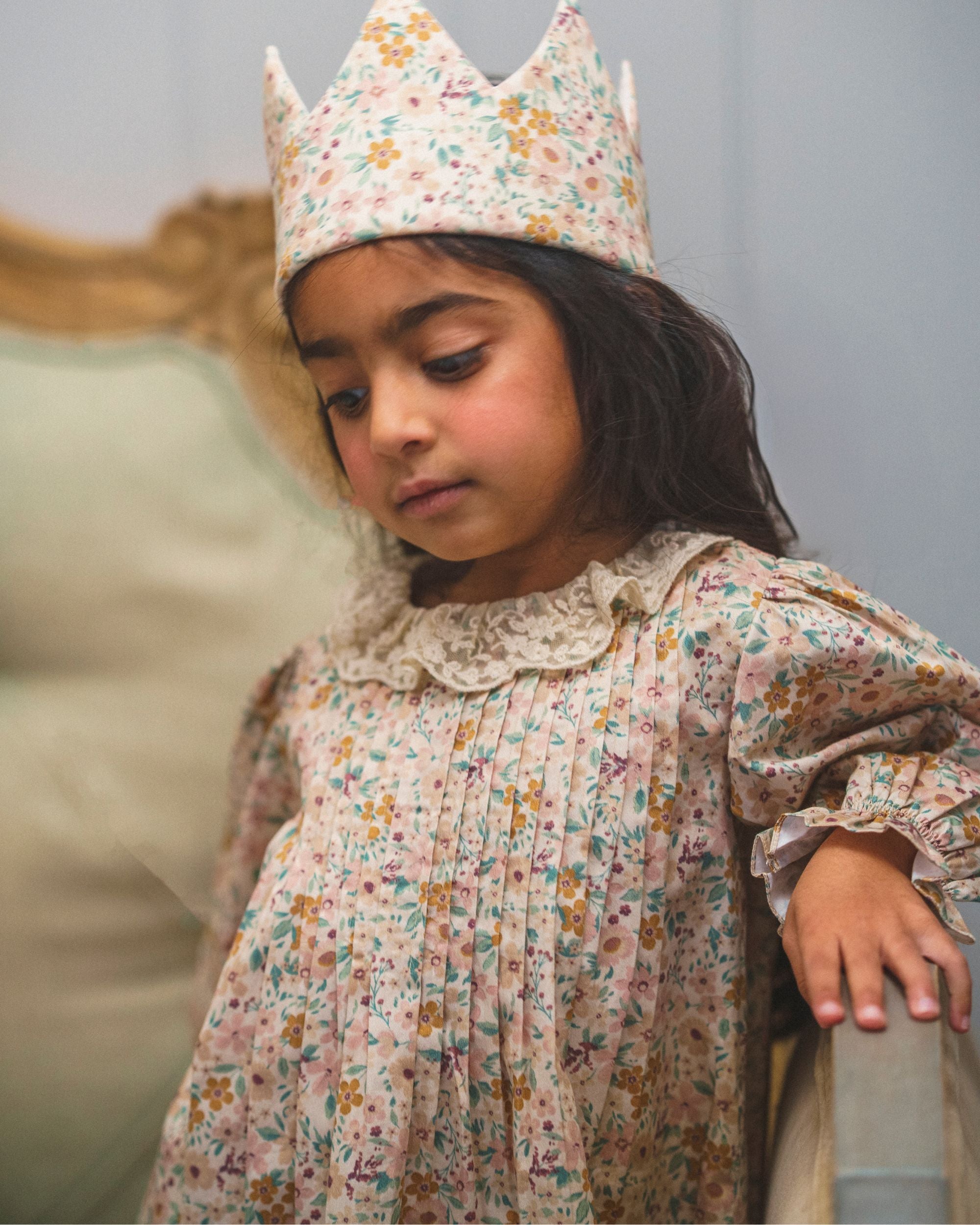 Early Sunday, Julie Dress in Floral print, made from Printed Cotton Satin fabric, featuring Delicate lace collar paired with a softly structured silhouette for a refined, timeless finish, shown in a close-up shot of a model wearing it during a studio shoot