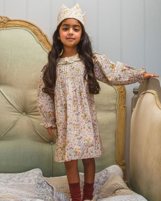 Early Sunday, Julie Dress in Floral print, made from Printed Cotton Satin fabric, featuring Delicate lace collar paired with a softly structured silhouette for a refined, timeless finish, shown in a front view of a model wearing it in a studio setting
