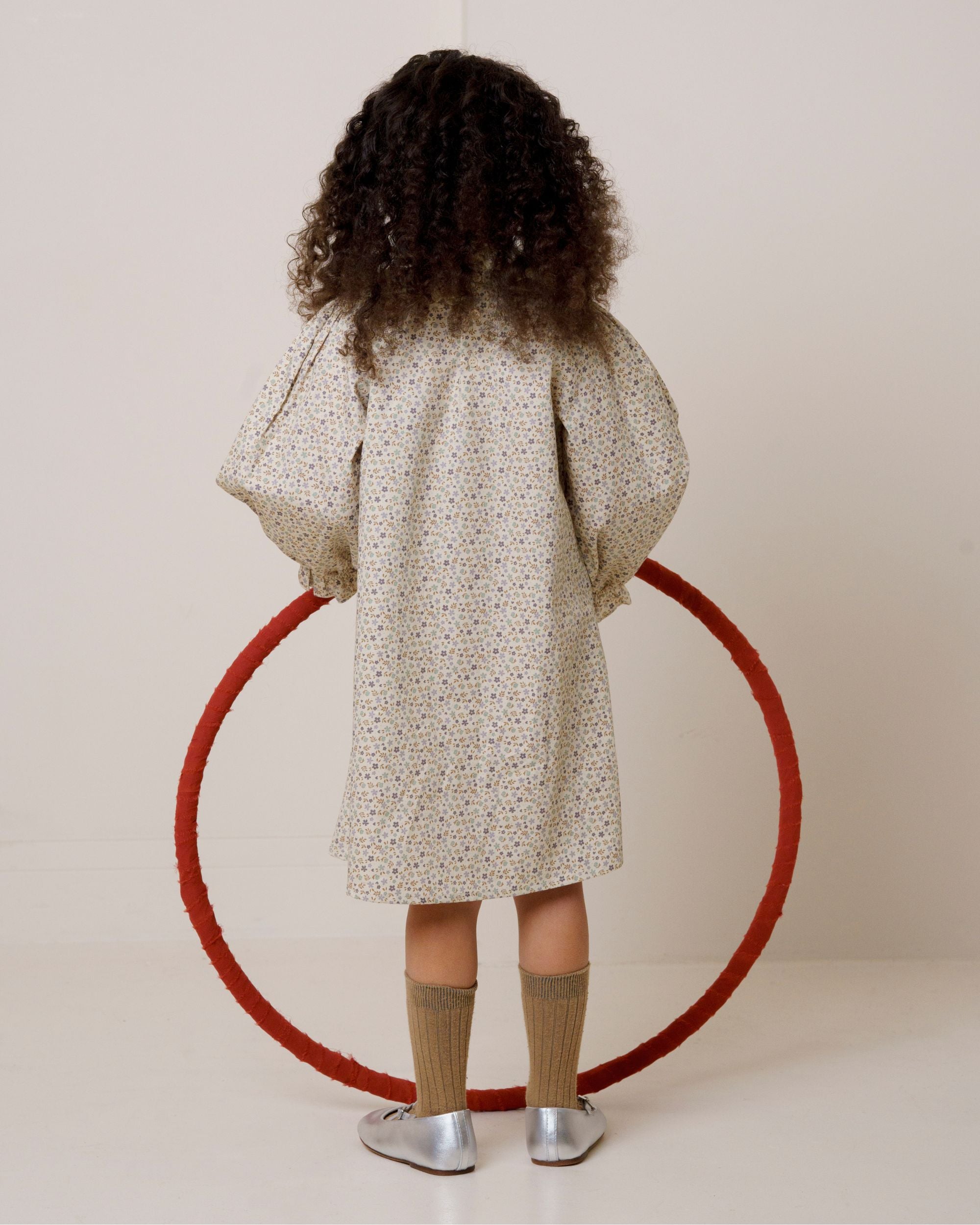 Early Sunday, Julie Dress in Miny Flowers print, made from Printed Cotton Satin fabric, featuring Delicate lace collar paired with a softly structured silhouette for a refined, timeless finish, shown in a back view of model wearing it