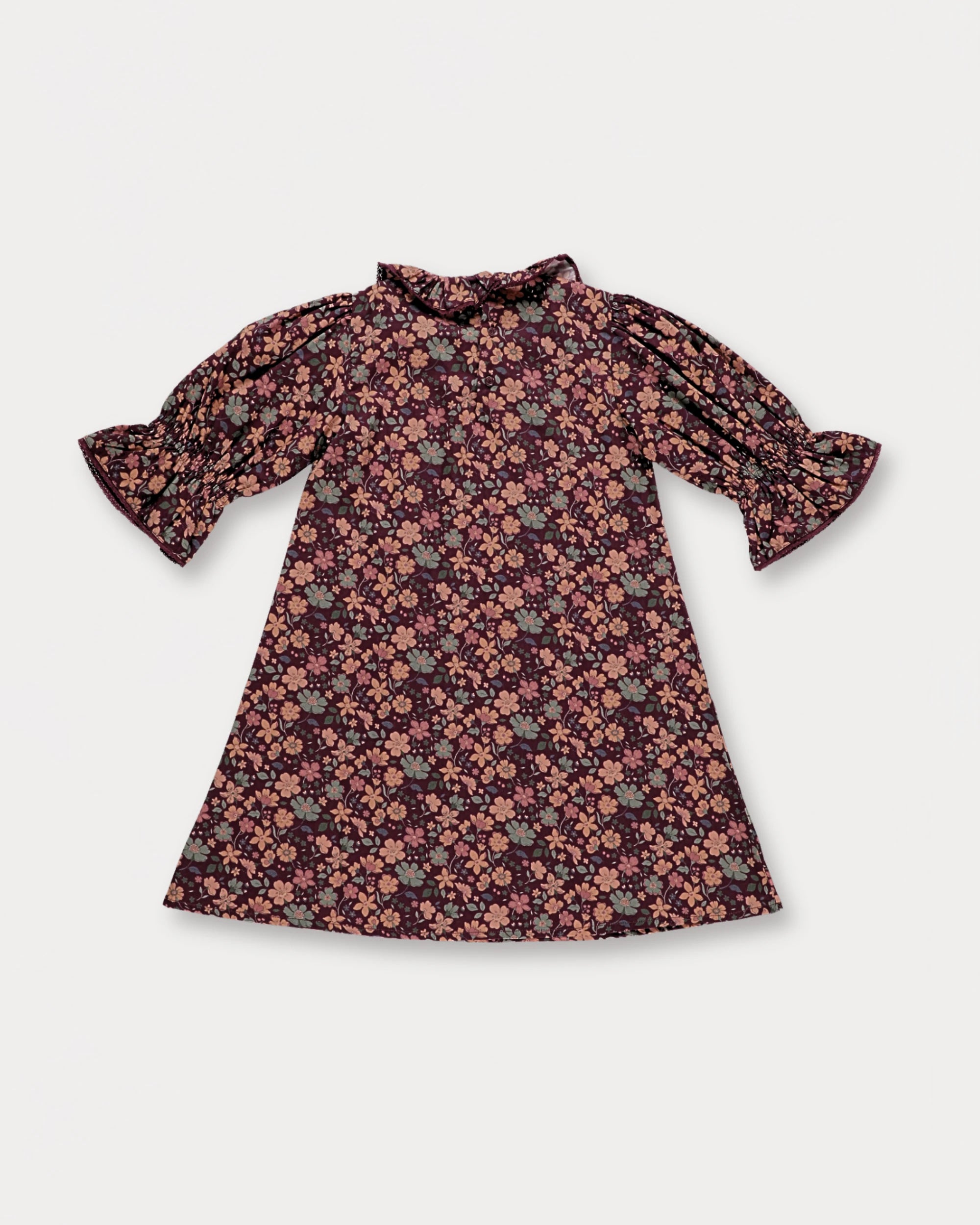 Early Sunday, Julie Dress in Plum, made from Printed Cotton Satin fabric, featuring detailed lace gathered sleeves with frilled neckline & floral detailing, shown in a back flat-lay view