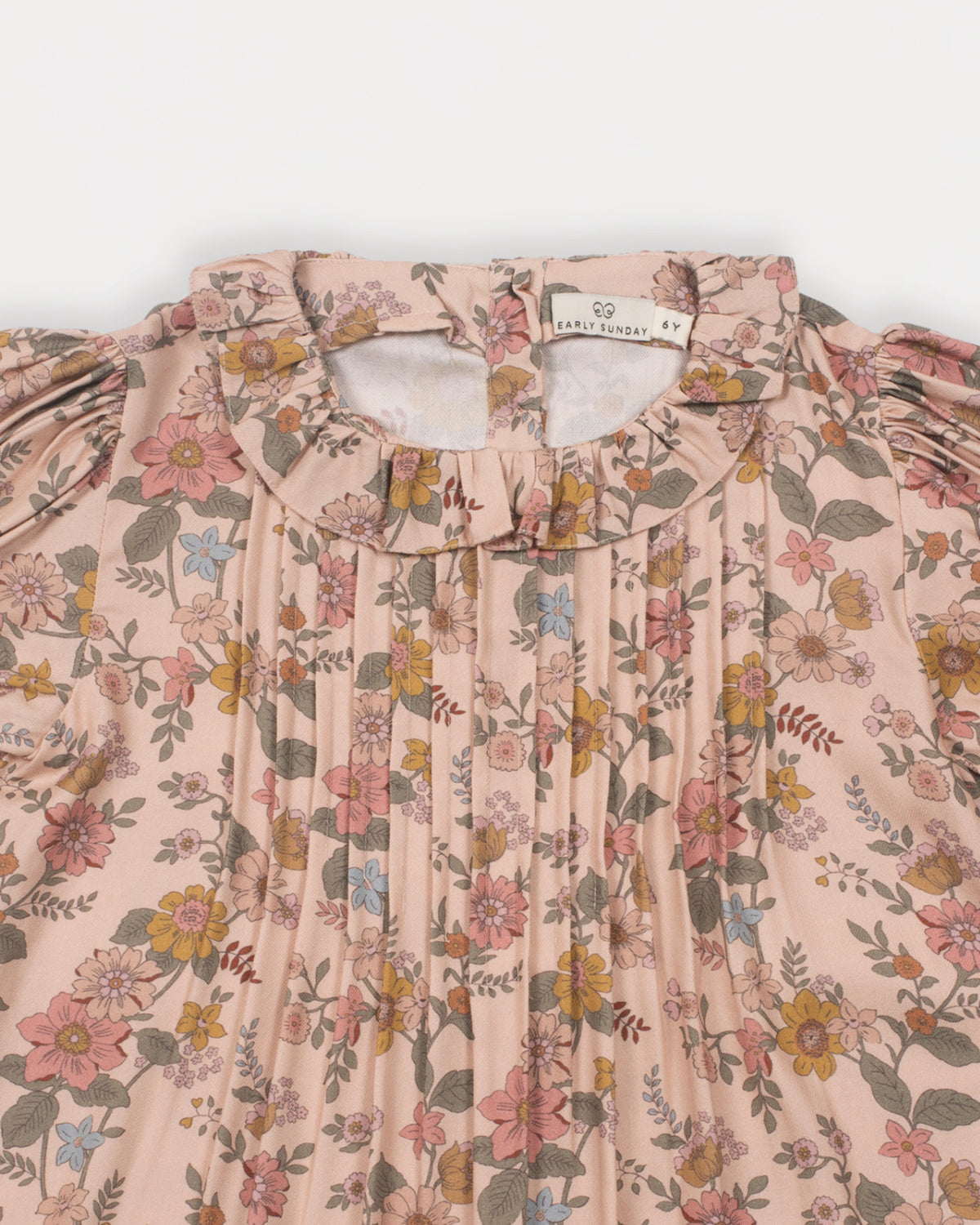 Early Sunday, Julie Dress in Bloom, made from Printed Viscose Twill fabric, featuring puffy gathered sleeves with frilled neckline, shown in a closeup flat-lay view