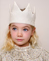 Early Sunday, Kids Crown in Hazelnut cream color, made from All over Embroidered Cotton Cambric fabric, featuring a design with pointed tips & an elasticated band, shown in a close up shot of model wearing it