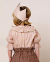 Early Sunday, Kids Crown in Feather print, made from Printed 60s Cotton Cambric fabric, featuring a design with pointed tips & an elasticated band, shown in a back view of model wearing it