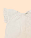 Early Sunday, Kitty Baby Blouse & Bloomer Set in Ivory color, made from 100% Cotton All Over Embroidery fabric, featuring a sleeveless flared sleeves with floral embroidery, shown in a closeup flat-lay view