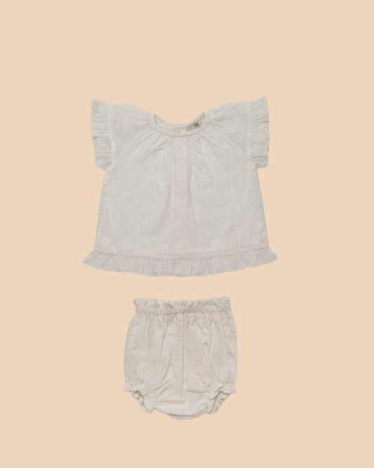 Early Sunday, Kitty Baby Blouse & Bloomer Set in Ivory color, made from 100% Cotton All Over Embroidery fabric, featuring a sleeveless flared sleeves with floral embroidery, shown in a front flat-lay view