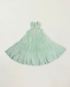 Early Sunday, Laura Dress in Mint color, made from 100% cotton double gauze solid fabric, featuring Crisscross ruffle straps with delicate trim accents and a softly gathered tiered skirt, shown in a front flat-lay view