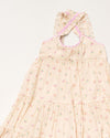 Early Sunday, Laura Dress in Butterfly Print color, made from printed cotton tiny swiss dobby fabric, featuring Crisscross ruffle straps with delicate trim accents and a softly gathered tiered skirt, shown in a closeup flat-lay view