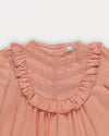 Early Sunday, Lauren Blouse in Blush, made from Cotton Jeera Dobby Voile fabric, featuring layered lace-trimmed ruffles and delicate pintuck detailing on the yoke, shown in a closeup flat-lay view