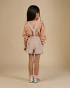 Early Sunday, Lauren Blouse in Earthy Pink, made from Cotton Swiss Dobby fabric, featuring relaxed fit with a floral embroidered yoke, shown in a back view of model wearing it