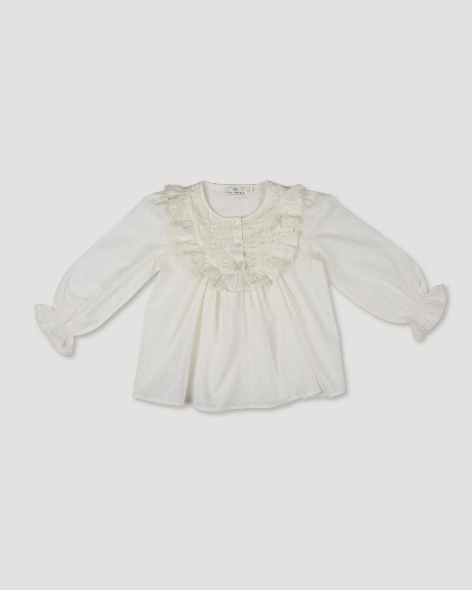 Early Sunday, Lauren Blouse in Ecru, made from Cotton Swiss Dobby fabric, featuring relaxed fit with a floral embroidered yoke, shown in a front flat-lay view
