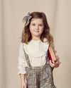 Early Sunday, Lauren Blouse in Ecru, made from Cotton Swiss Dobby fabric, featuring relaxed fit with a floral embroidered yoke, shown in a front view of a model wearing it in a studio setting
