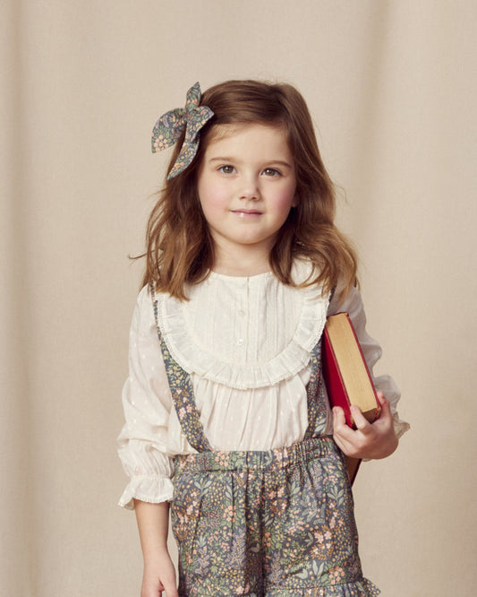 Early Sunday, Lauren Blouse in Ecru, made from Cotton Swiss Dobby fabric, featuring relaxed fit with a floral embroidered yoke, shown in a front view of a model wearing it in a studio setting