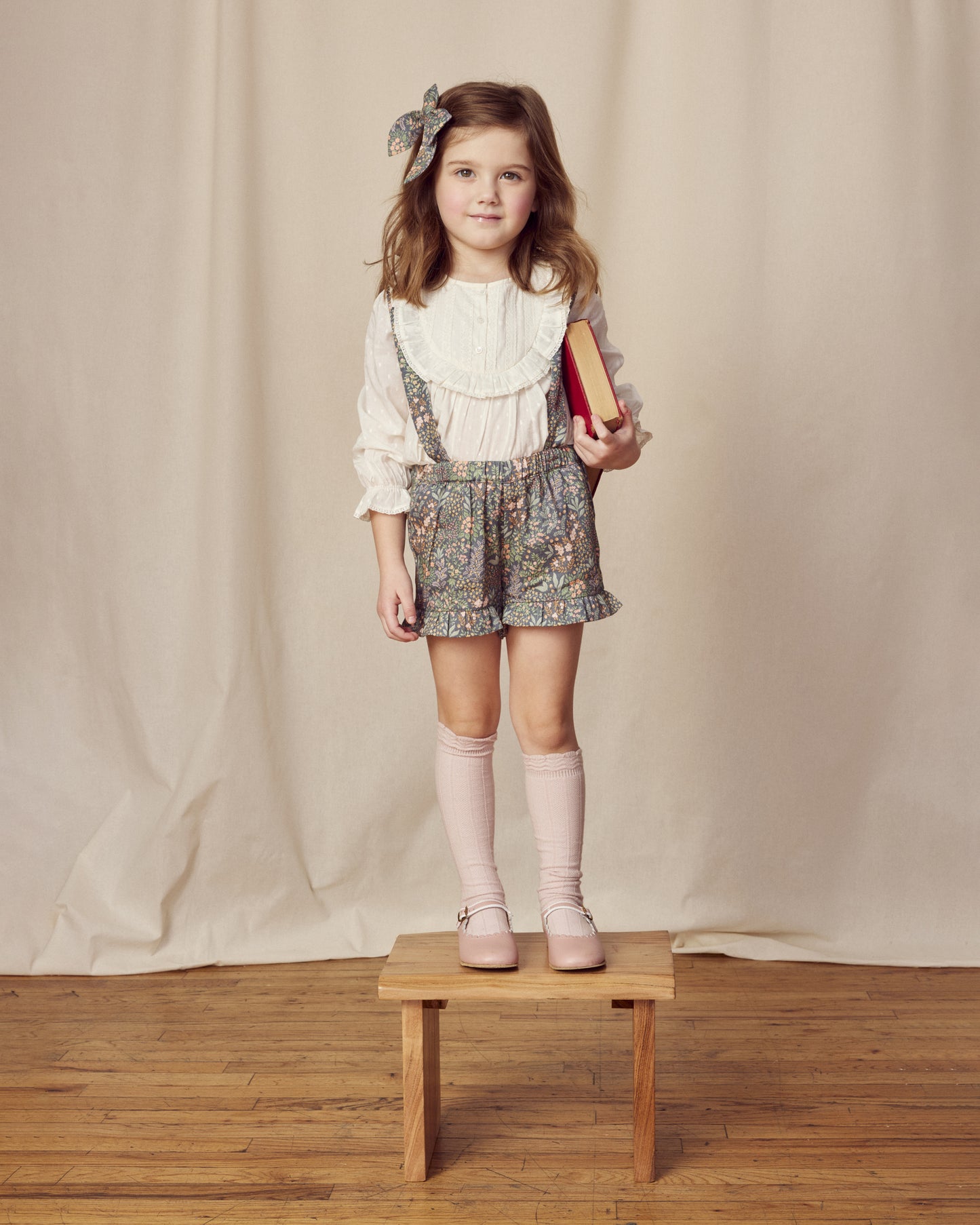 Early Sunday, Lauren Blouse in Ecru, made from Cotton Swiss Dobby fabric, featuring relaxed fit with a floral embroidered yoke, shown in a front view of model wearing it