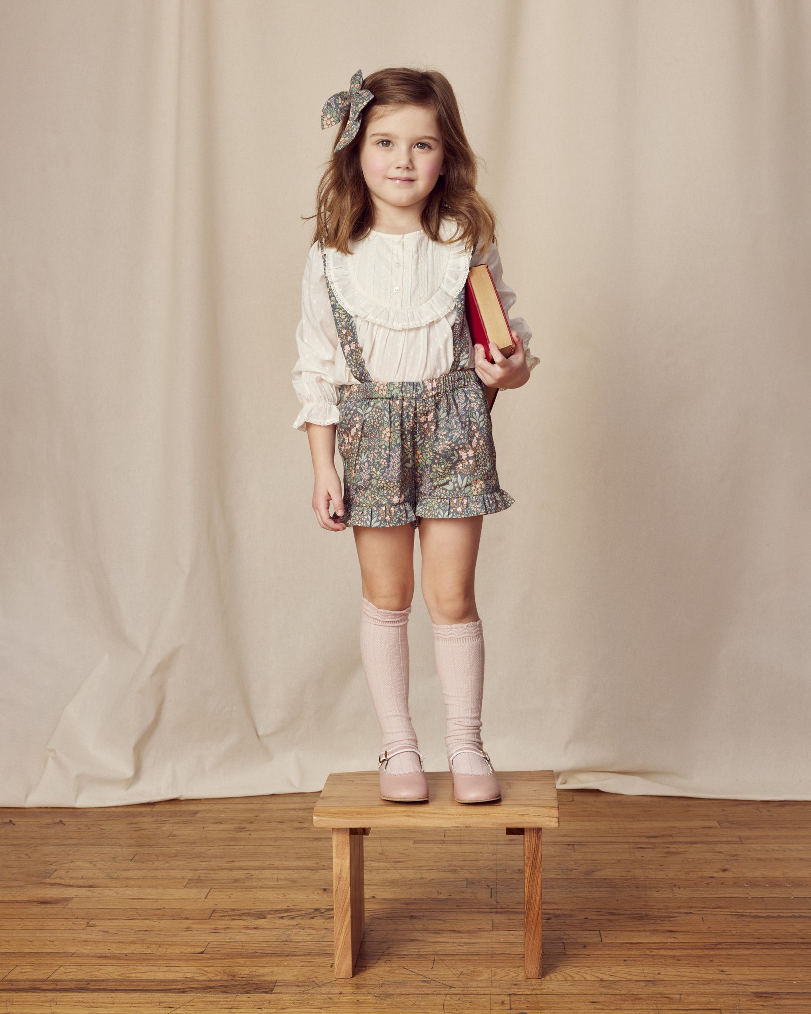 Early Sunday, Lauren Blouse in Ecru, made from Cotton Swiss Dobby fabric, featuring relaxed fit with a floral embroidered yoke, shown in a front view of model wearing it