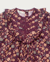 Early Sunday, Lauren Blouse in Plum, made from Printed Cotton Satin fabric, featuring layered lace-trimmed ruffles and delicate pintuck detailing on the yoke, shown in a closeup flat-lay view