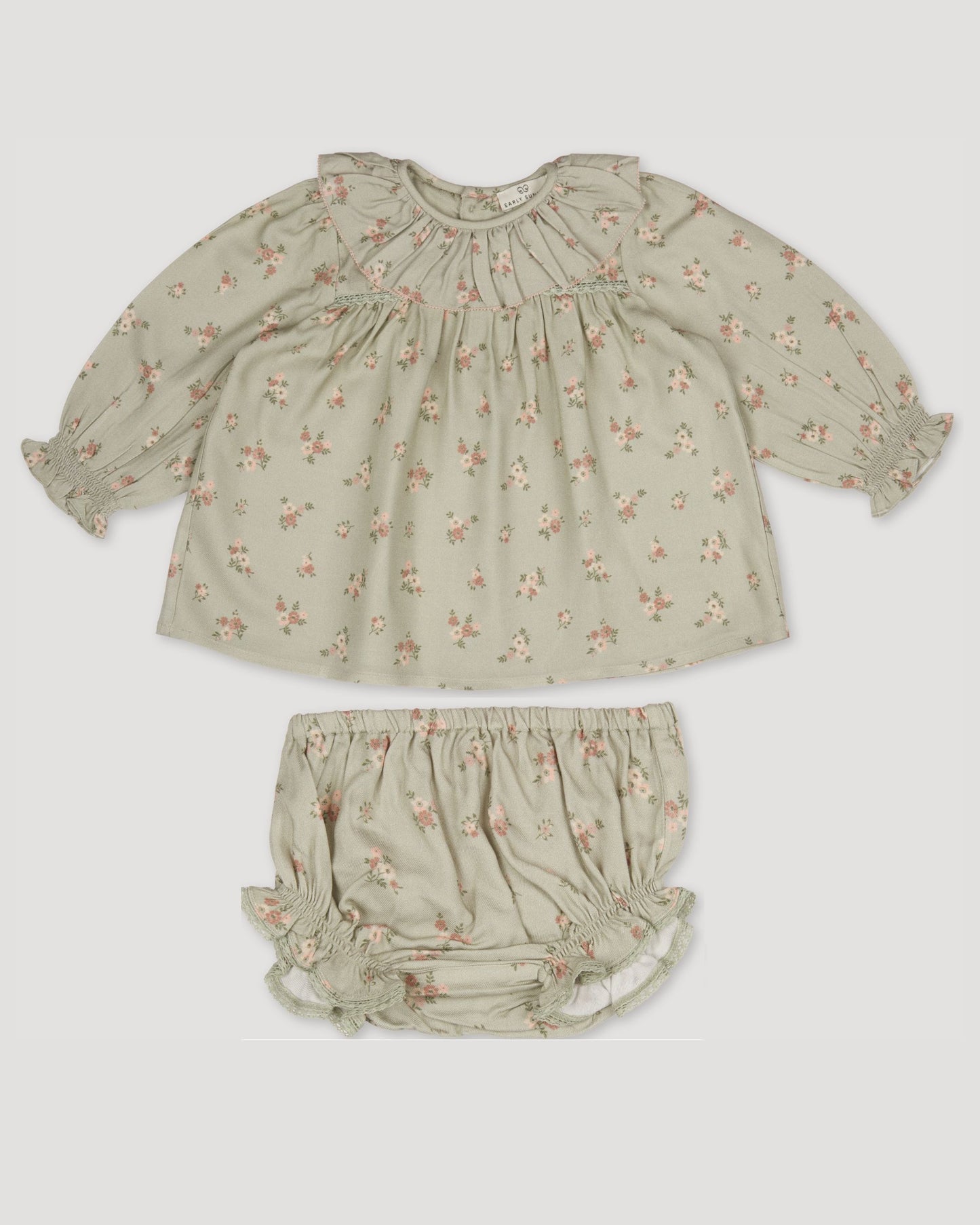 Early Sunday, Libby Baby Dress & Bloomer Set in Ditsy Bouquet Jade print, made from Printed Viscose Rayon Twill fabric, featuring long sleeves with frilly neck & floral print, shown in a front flat-lay view