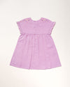 Early Sunday, Lila Dress in Lilac color, made from 70% cotton 30% linen solid fabric, featuring Scalloped neckline with contrast stitching, flutter sleeves, gentle gathers, and embroidered hem detail, shown in a back flat-lay view