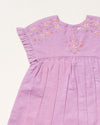 Early Sunday, Lila Dress in Lilac color, made from 70% cotton 30% linen solid fabric, featuring Scalloped neckline with contrast stitching, flutter sleeves, gentle gathers, and embroidered hem detail, shown in a closeup flat-lay view