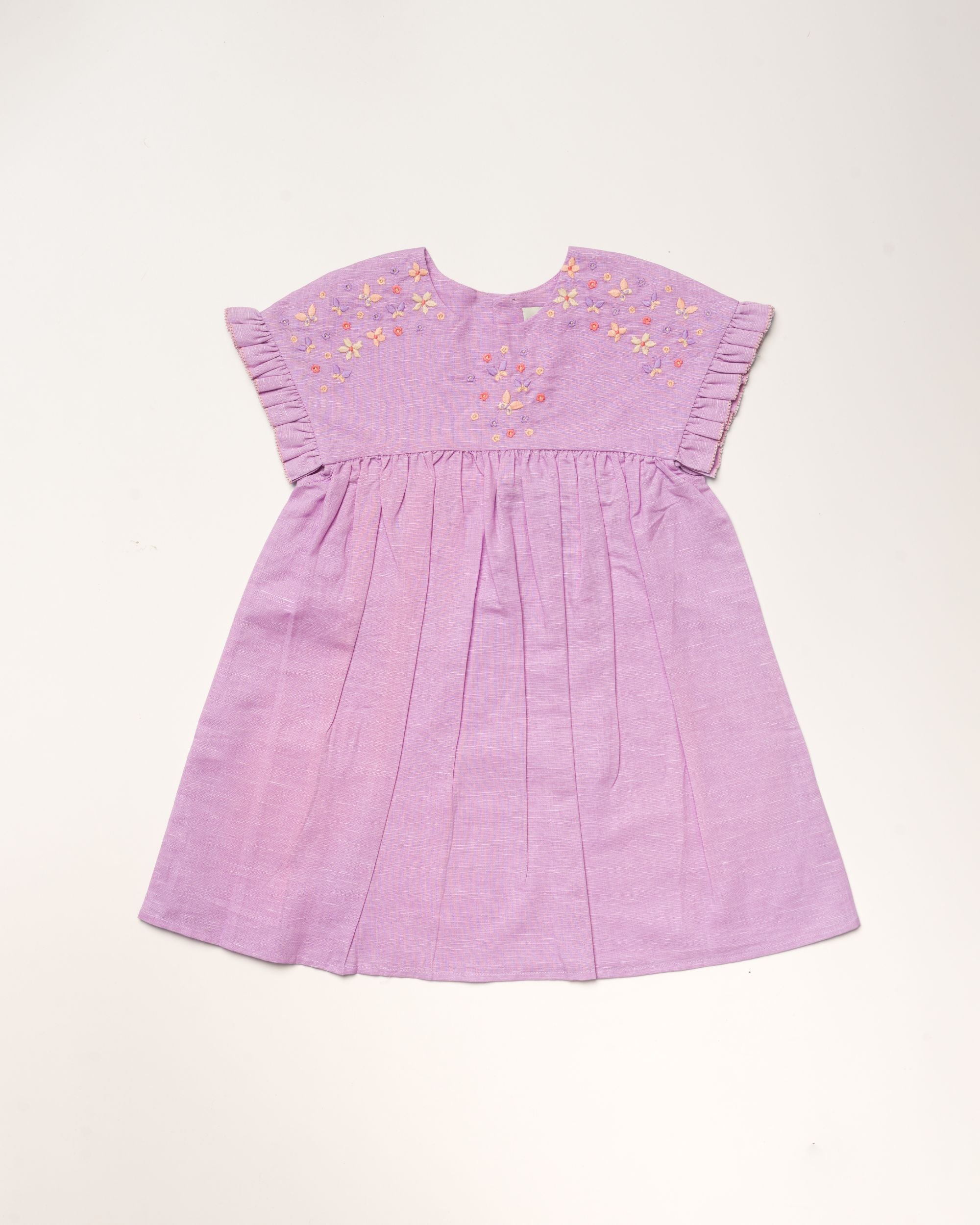 Early Sunday, Lila Dress in Lilac color, made from 70% cotton 30% linen solid fabric, featuring Scalloped neckline with contrast stitching, flutter sleeves, gentle gathers, and embroidered hem detail, shown in a front flat-lay view