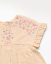 Early Sunday, Lila Dress in Sand color, made from 70% cotton 30% linen solid fabric, featuring Scalloped neckline with contrast stitching, flutter sleeves, gentle gathers, and embroidered hem detail, shown in a closeup flat-lay view