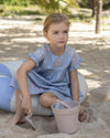Early Sunday, Lila Dress in Ocean Blue color, made from Canvas 70% Cotton 30% Linen fabric, featuring a flattering mini dress with a relaxed fit, designed for comfort and effortless style, shown in close up shot of model playing outdoors