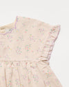 Early Sunday, Lila Dress in Painted Bouquet color, made from printed 70% cotton 30% linen fabric, featuring Scalloped neckline with contrast stitching, flutter sleeves, gentle gathers, and embroidered hem detail, shown in a closeup flat-lay view