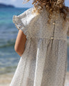 Early Sunday, Lila Dress in Mini Flower print, made from Printed canvas 70% Cotton 30% Linen fabric, featuring a flattering mini dress with a relaxed fit, designed for comfort and effortless style, shown in a back view of model wearing it