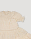 Early Sunday, Lilly Dress in Hazelnut Cream, made from All-Over Embroidered Cotton Cambric fabric, featuring Delicate floral embroidery placed softly across the dress for a timeless, heirloom-inspired finish, shown in a closeup flat-lay view