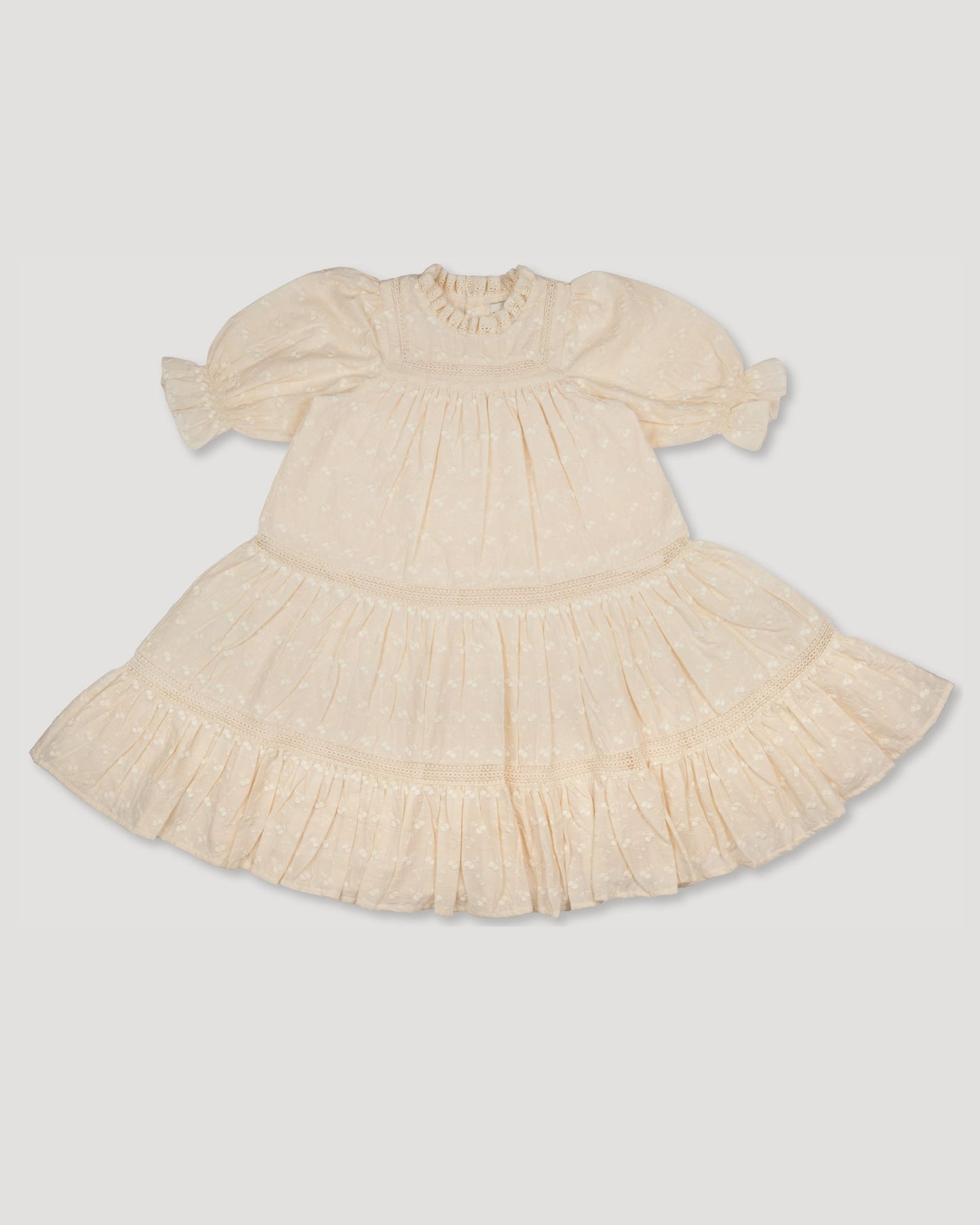 Early Sunday, Lilly Dress in Hazelnut Cream, made from All-Over Embroidered Cotton Cambric fabric, featuring Delicate floral embroidery placed softly across the dress for a timeless, heirloom-inspired finish, shown in a front flat-lay view