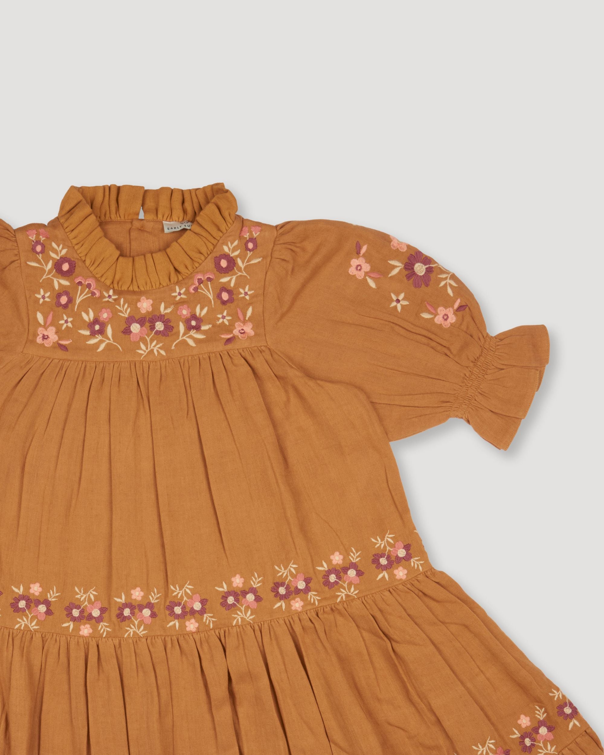 Early Sunday, Lilly Dress in Almond, made from Dyed Cotton Double Gauze fabric, featuring Delicate floral embroidery placed softly across the dress for a timeless, heirloom-inspired finish, shown in a closeup flat-lay view