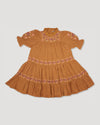 Early Sunday, Lilly Dress in Almond, made from Dyed Cotton Double Gauze fabric, featuring Delicate floral embroidery placed softly across the dress for a timeless, heirloom-inspired finish, shown in a front flat-lay view