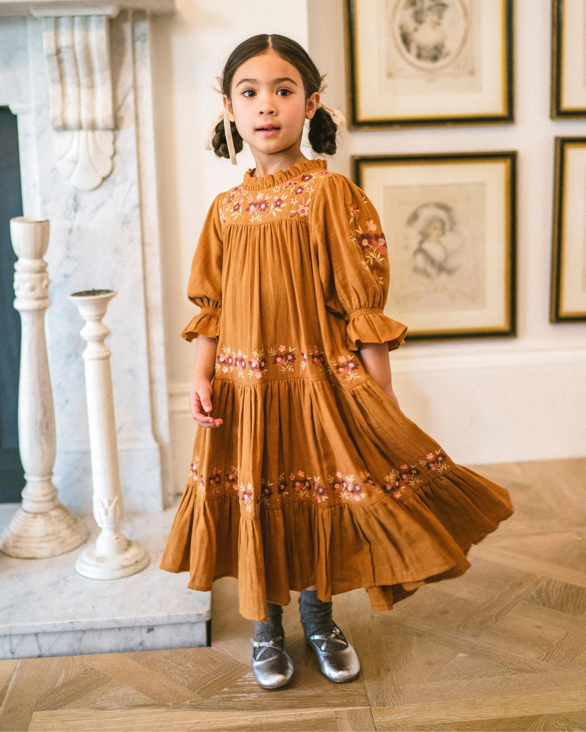 Early Sunday, Lilly Dress in Almond, made from Dyed Cotton Double Gauze fabric, featuring Delicate floral embroidery placed softly across the dress for a timeless, heirloom-inspired finish, shown in a front view of a model wearing it in a studio setting