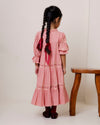Early Sunday, Lilly Dress in Rose, made from Dyed Cotton Double Gauze fabric, featuring Delicate floral embroidery placed softly across the dress for a timeless, heirloom-inspired finish, shown in a back view of model wearing it