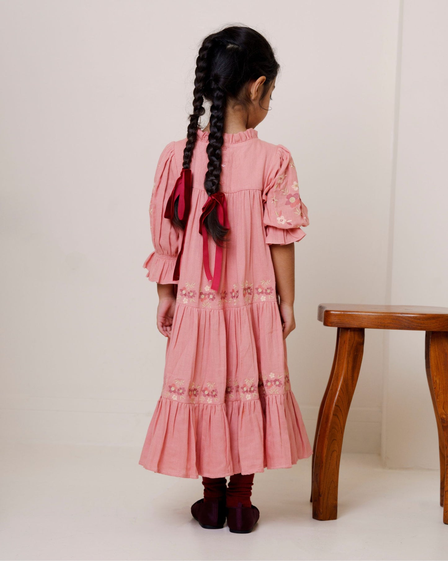 Early Sunday, Lilly Dress in Rose, made from Dyed Cotton Double Gauze fabric, featuring Delicate floral embroidery placed softly across the dress for a timeless, heirloom-inspired finish, shown in a back view of model wearing it