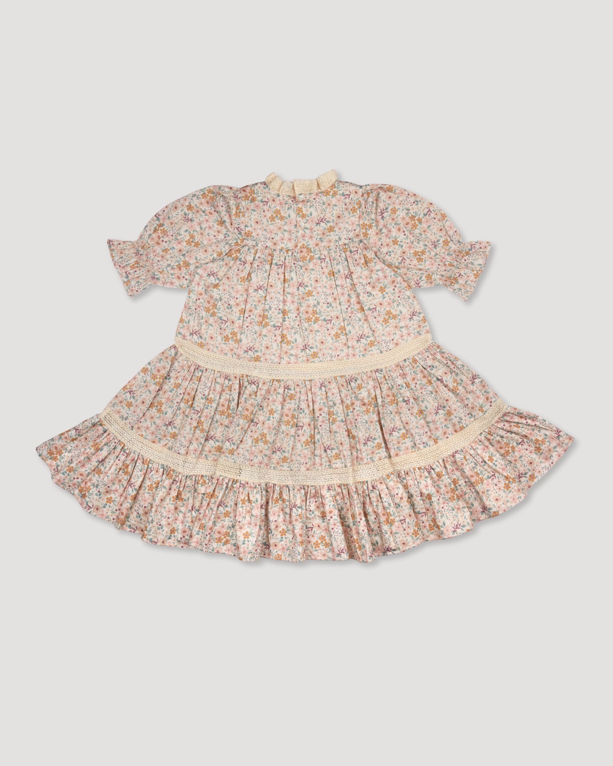 Early Sunday, Lilly Dress in Floral print, made from Printed Cotton Satin fabric, featuring Delicate floral embroidery placed softly across the dress for a timeless, heirloom-inspired finish, shown in a back flat-lay view